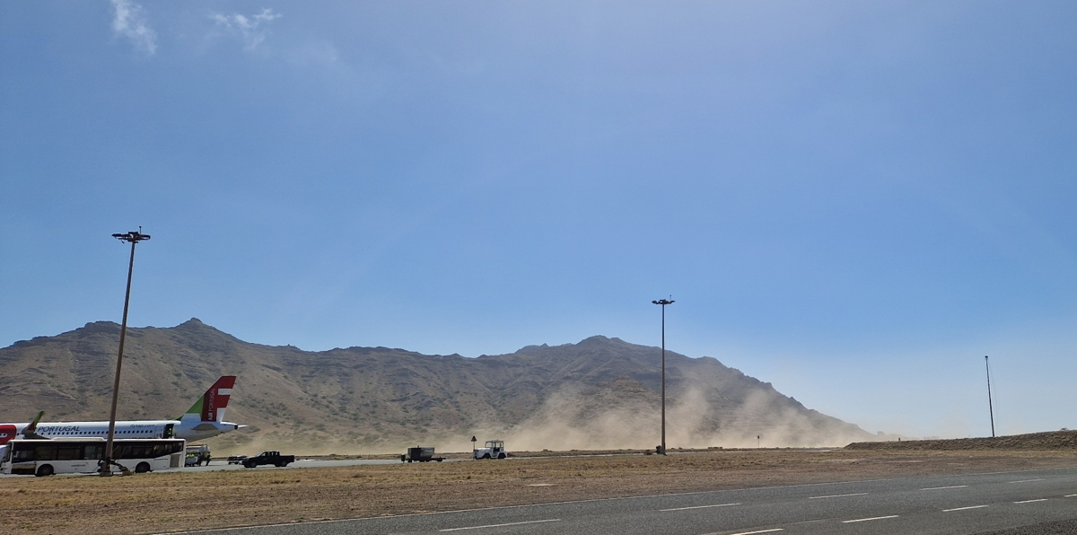 Dust plumes are blown across the airport's landing strip