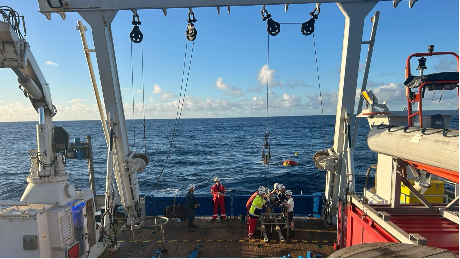 The crew and Ben deploying the mooring with the calcium carbonate shells of tiny little creatures