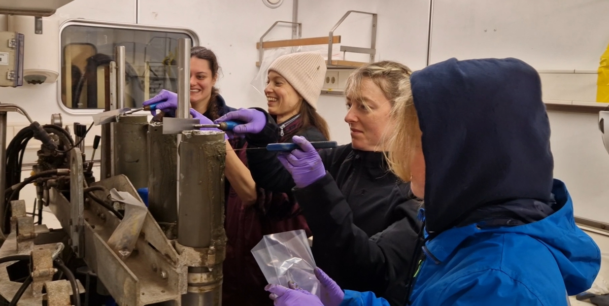 Happy faces in the temperature-controlled (10C) lab container where the cores are sliced